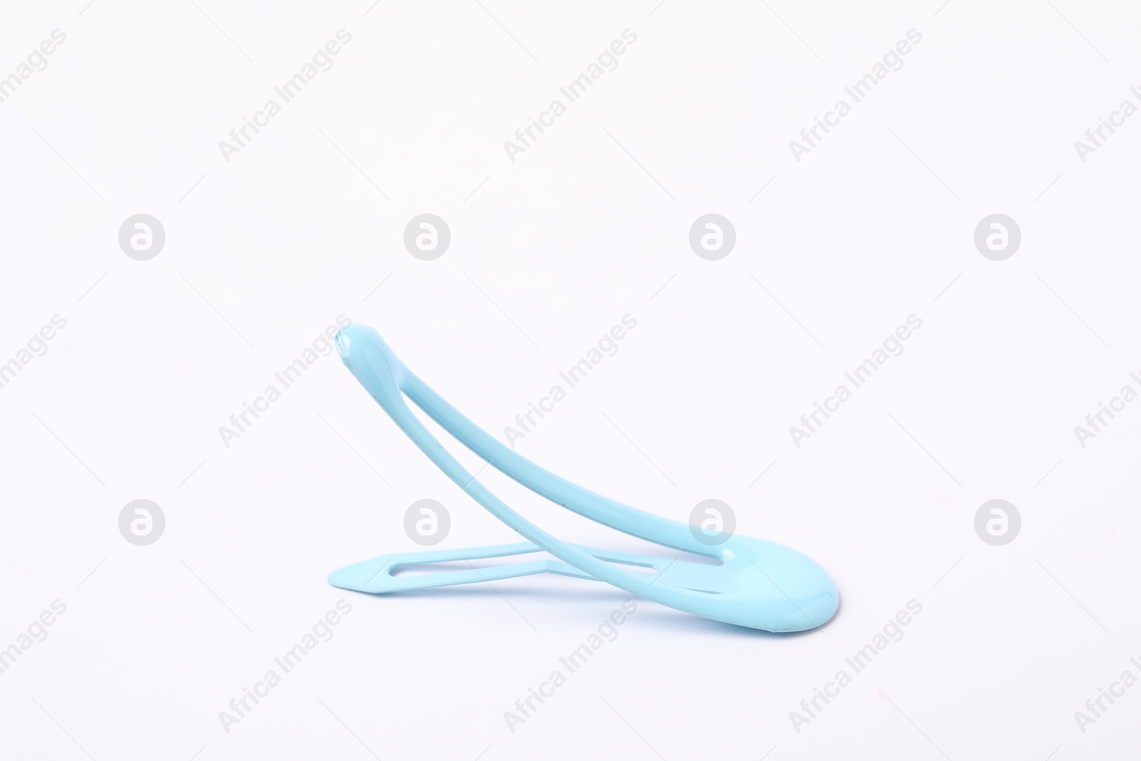 Photo of One blue hair clip on white background