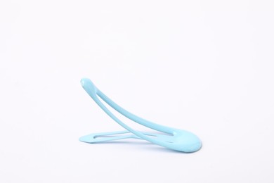 Photo of One blue hair clip on white background