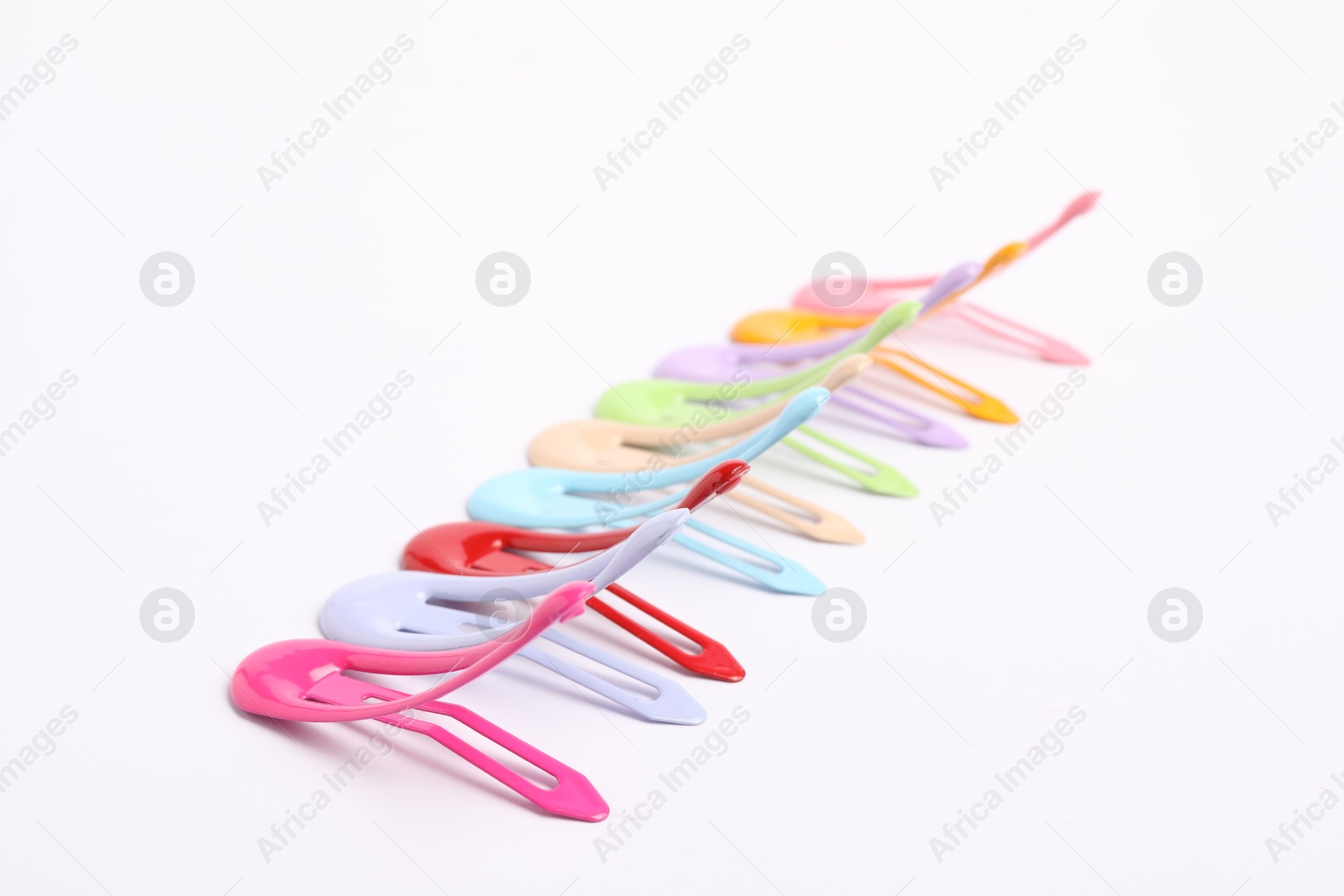 Photo of Many colorful hair clips on white background