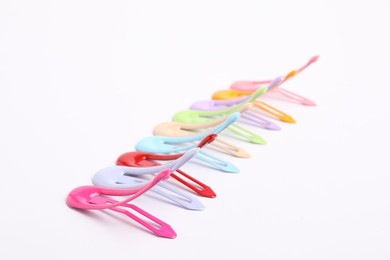 Photo of Many colorful hair clips on white background