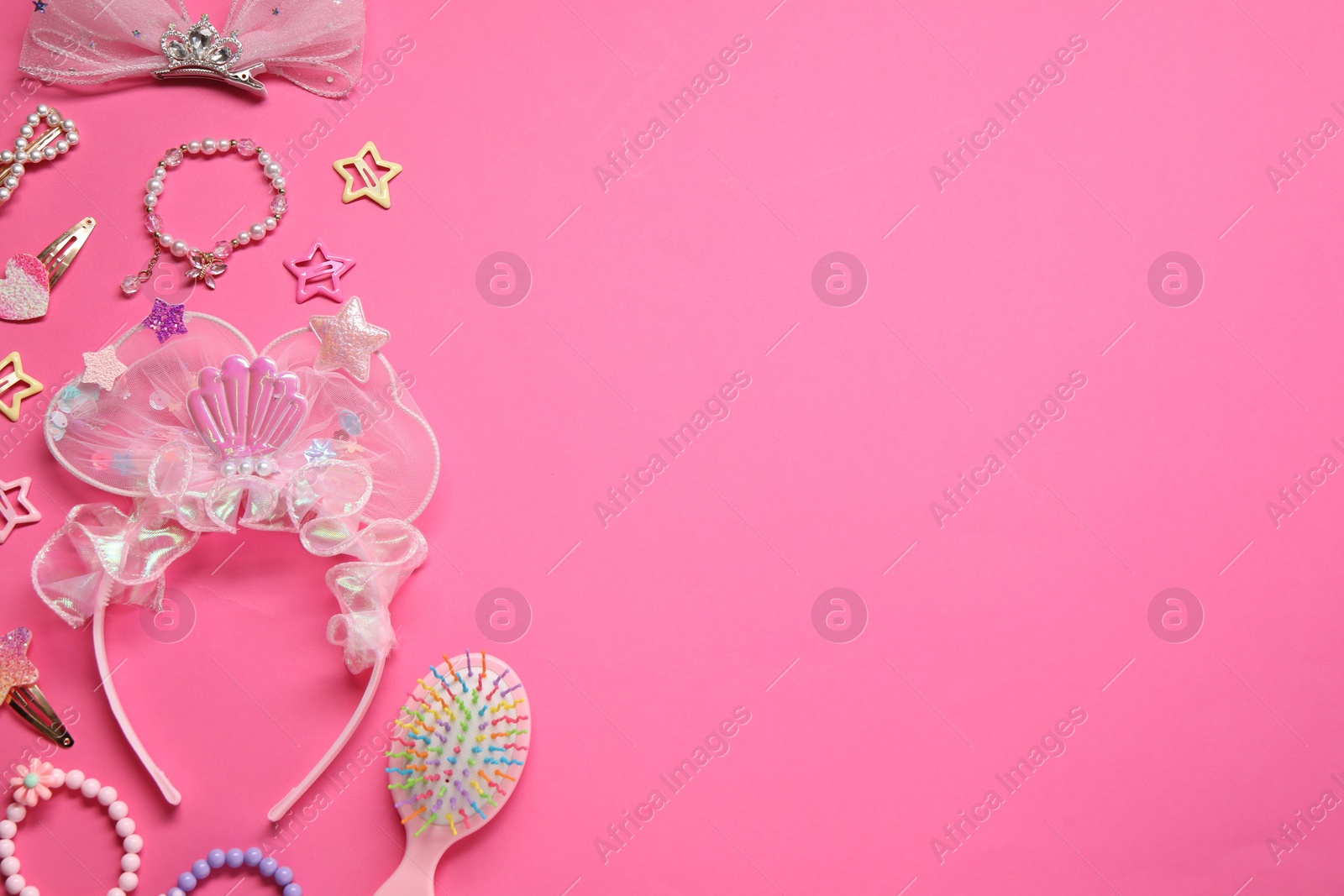 Photo of Cute hair accessories on pink background, flat lay. Space for text