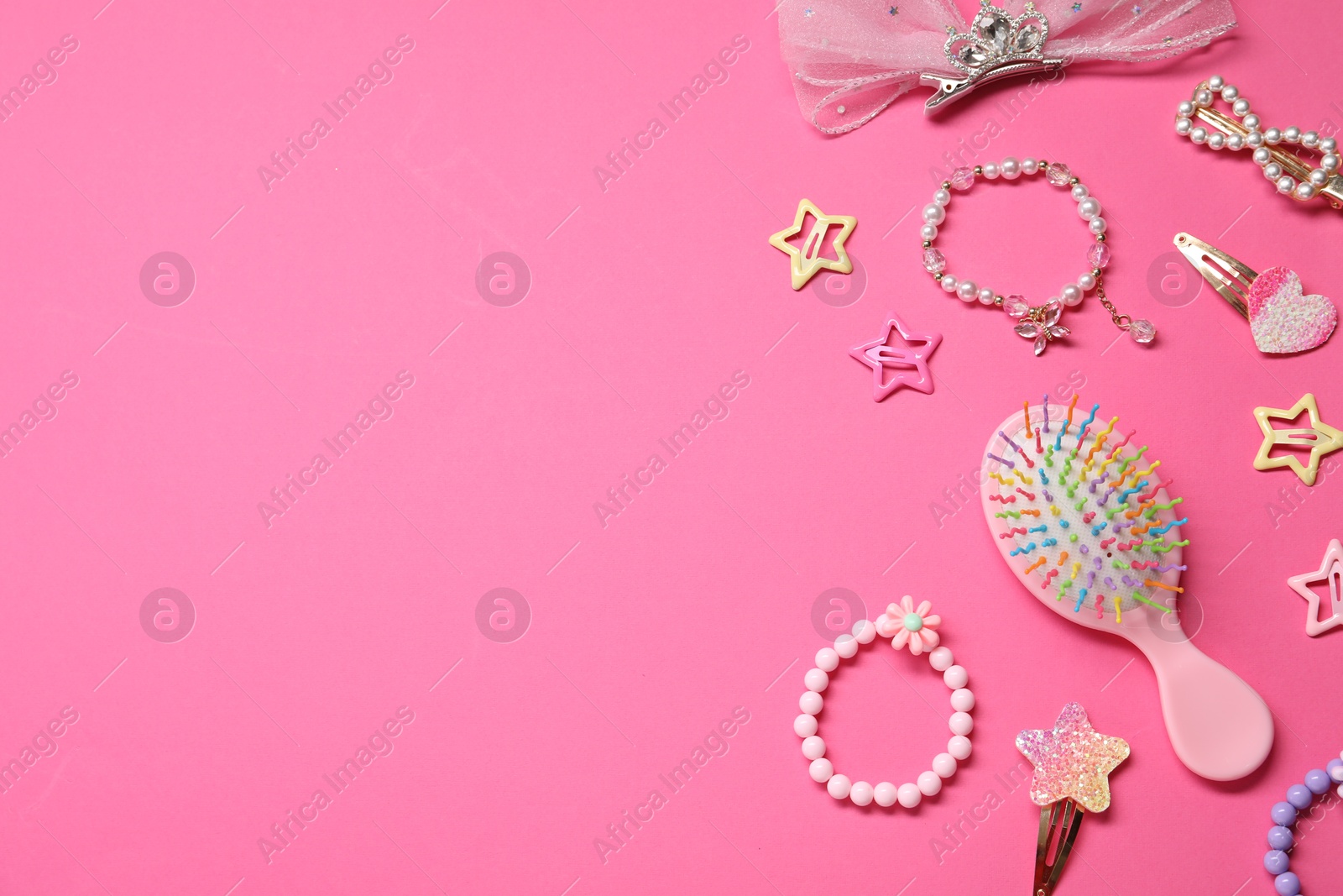 Photo of Cute hair accessories on pink background, flat lay. Space for text