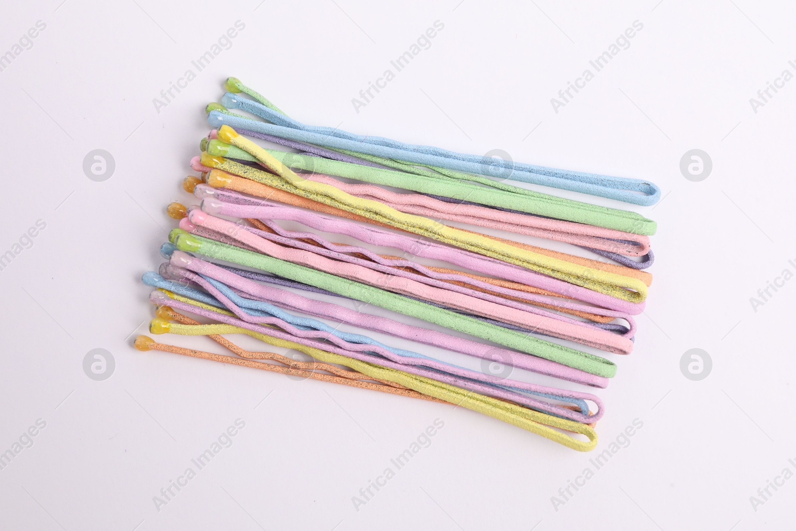 Photo of Many colorful hair pins on white background, top view