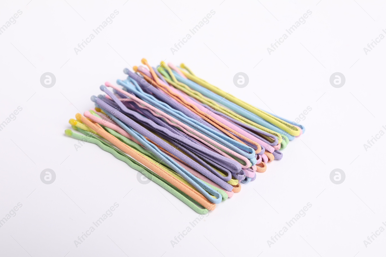 Photo of Many colorful hair pins on white background