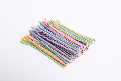 Photo of Many colorful hair pins on white background