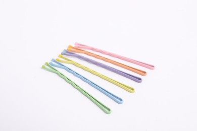 Photo of Many colorful hair pins on white background