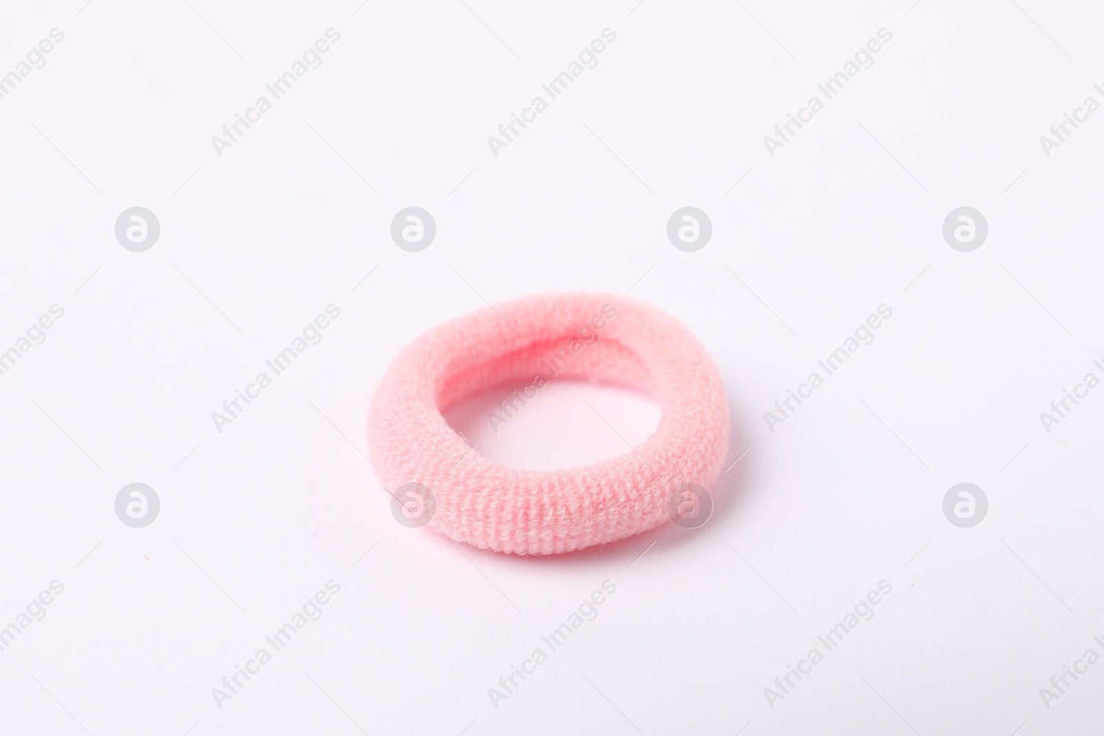 Photo of One pink hair tie on white background