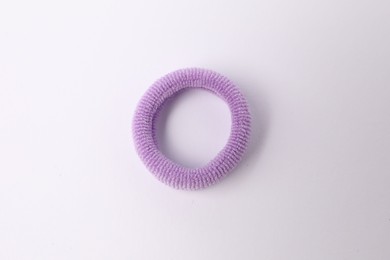 Photo of One violet hair tie on white background, top view