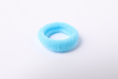 Photo of One blue hair tie on white background