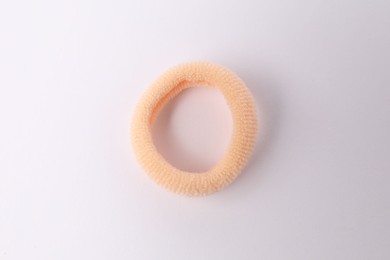 Photo of One peach hair tie on white background, top view