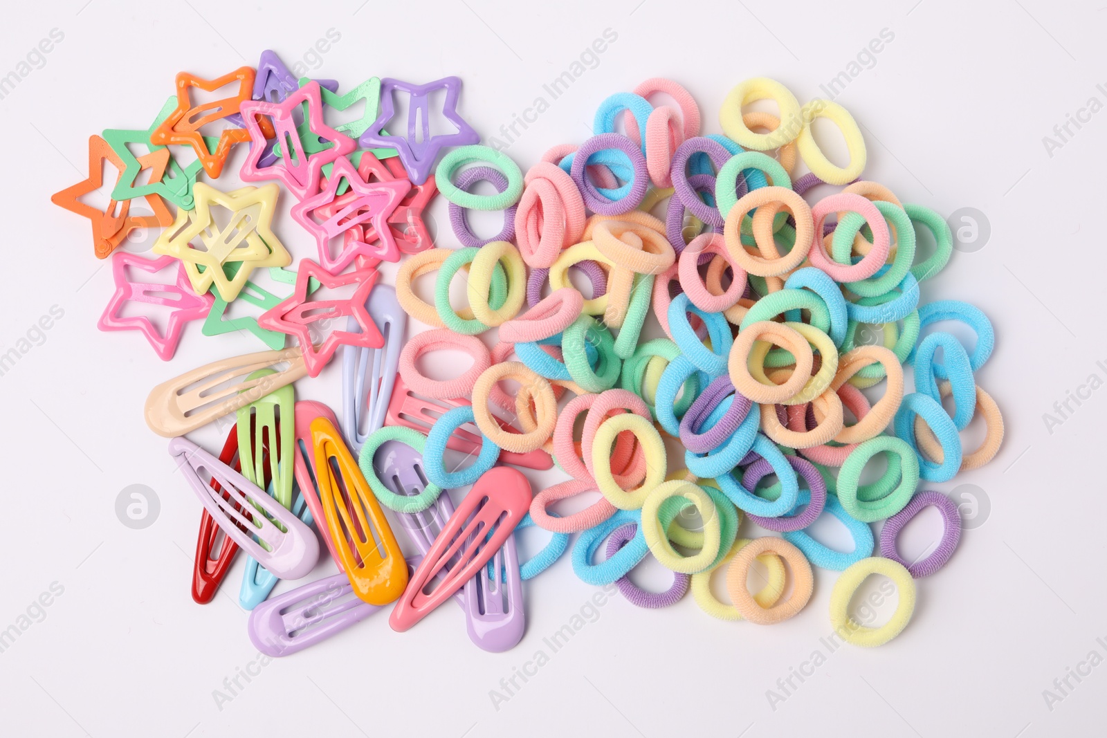 Photo of Colorful cute hair accessories on white background, top view