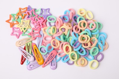 Photo of Colorful cute hair accessories on white background, top view