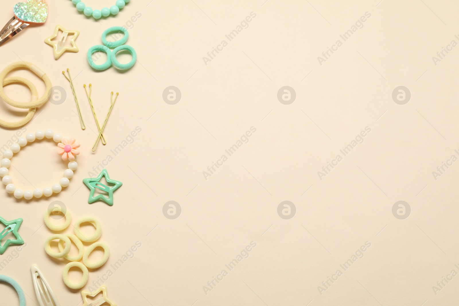 Photo of Cute hair accessories on beige background, flat lay. Space for text