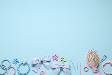 Photo of Cute hair accessories on light blue background, flat lay. Space for text