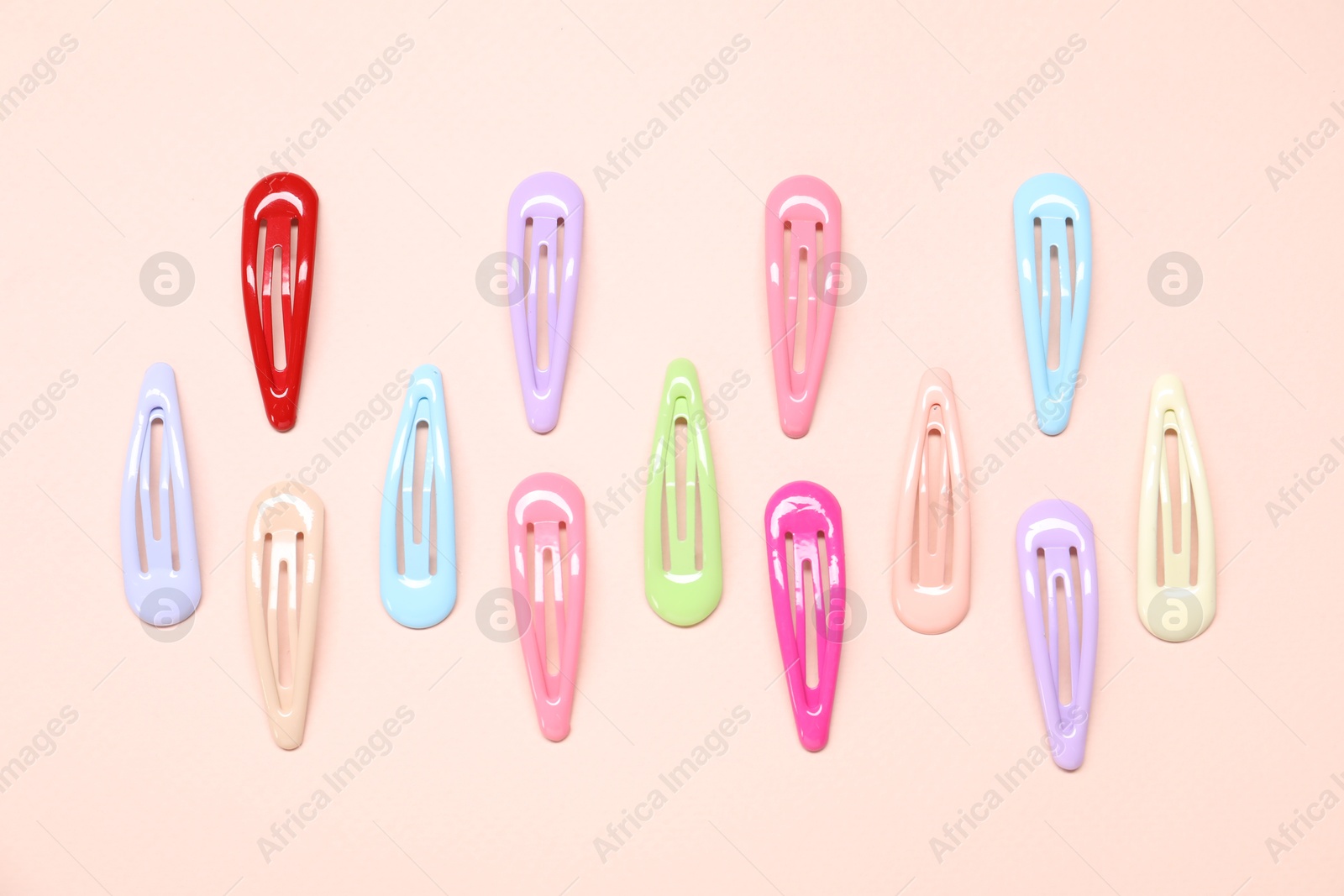 Photo of Colorful hair clips on light background, flat lay