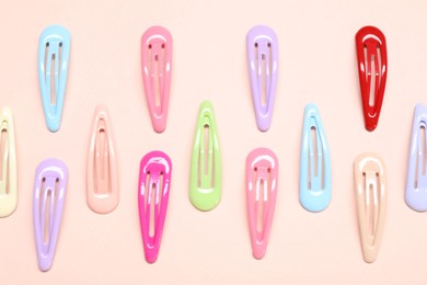 Photo of Colorful hair clips on light background, flat lay