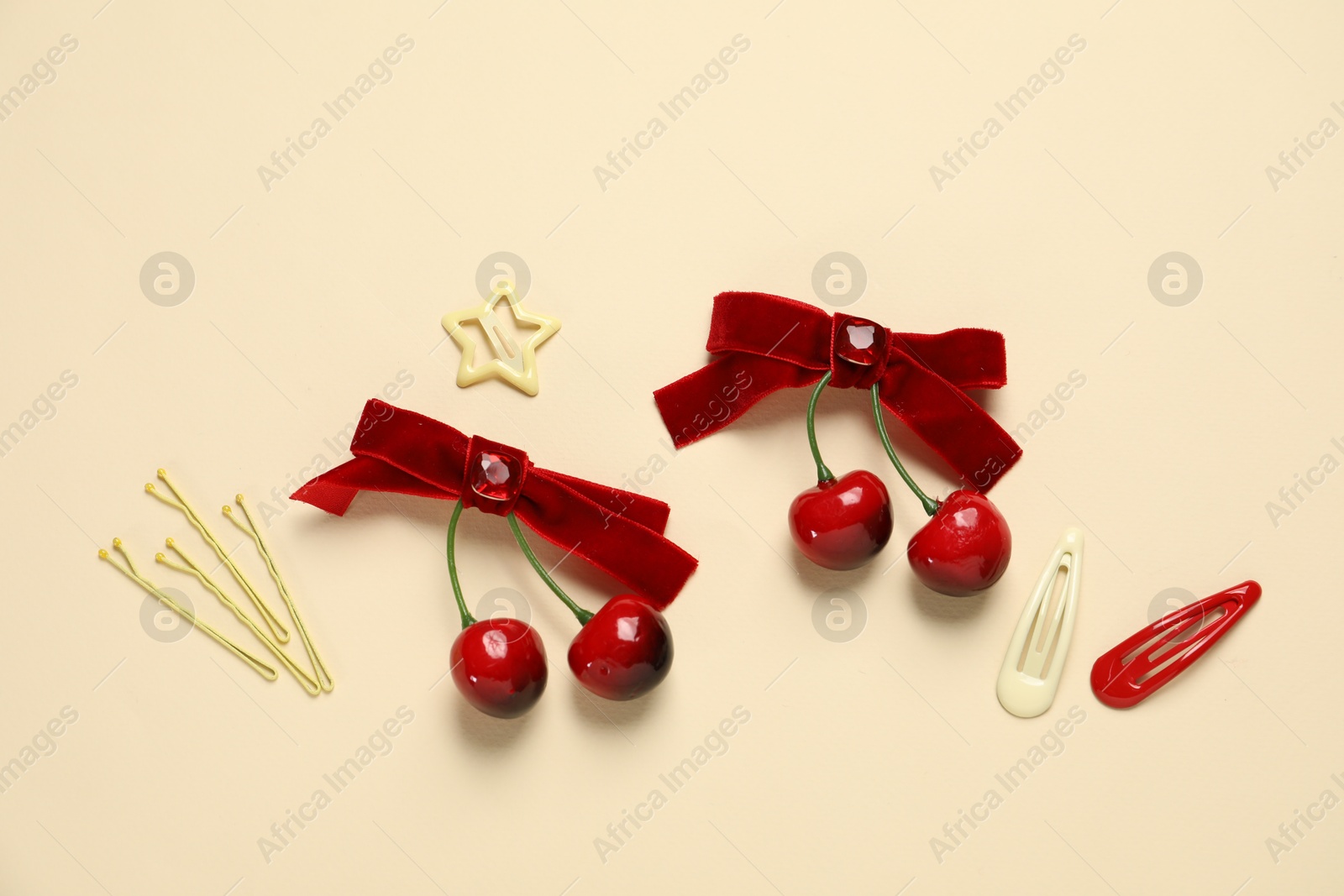 Photo of Cute hair accessories on beige background, flat lay