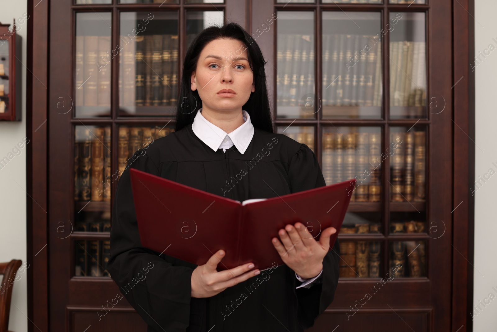 Photo of Judge with folder of documents in office