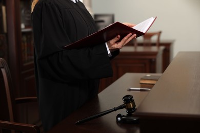 Photo of Judge with folder of documents in courtroom, closeup