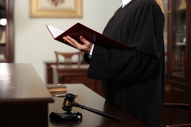 Photo of Judge with folder of documents in courtroom, closeup