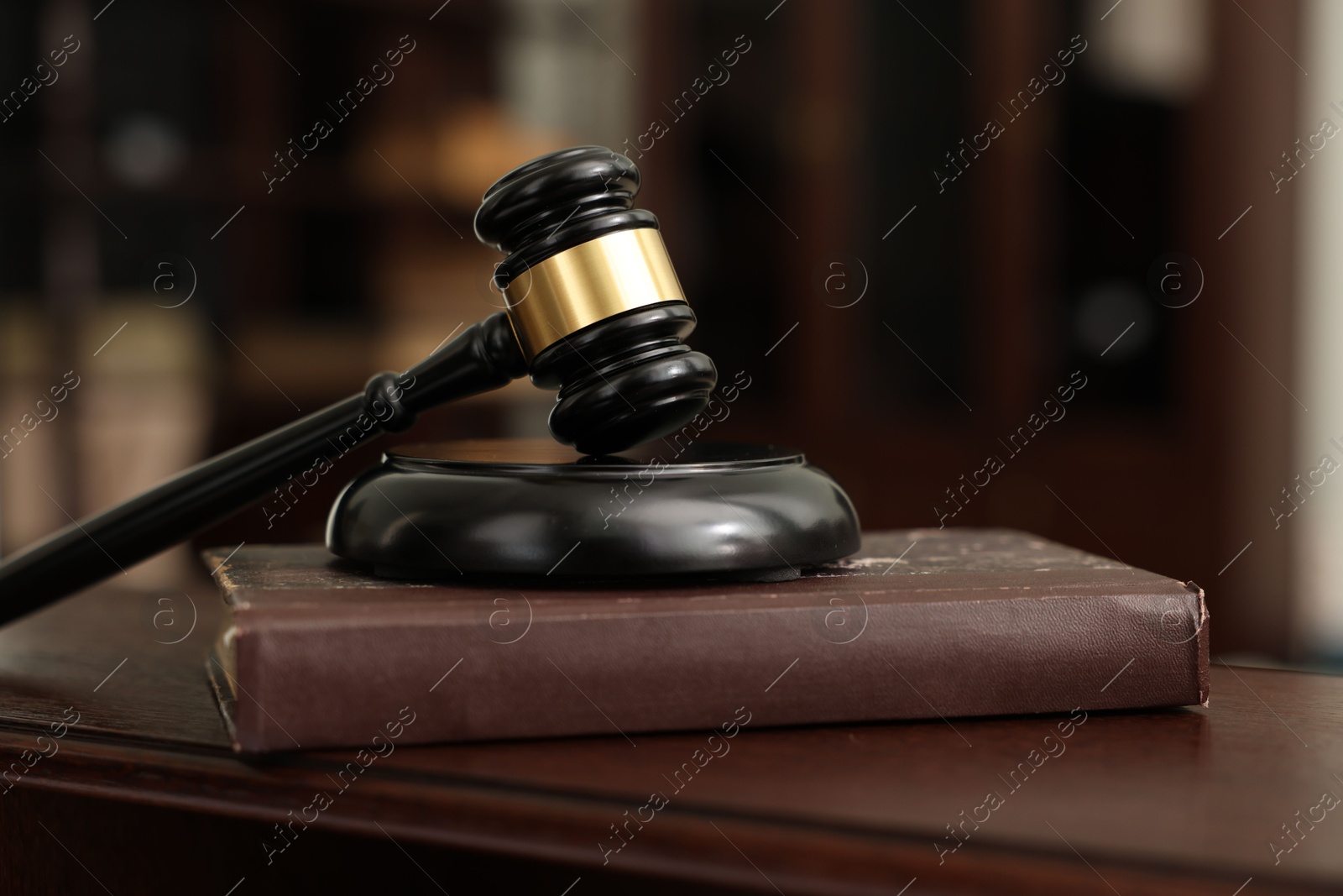 Photo of Judge workplace with gavel and book indoors