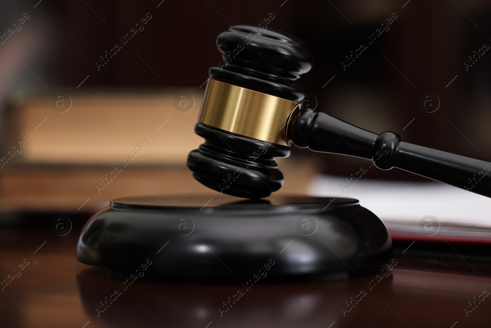 Photo of Judge workplace with gavel and books indoors, closeup