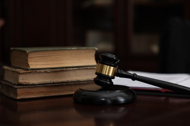 Photo of Judge workplace with gavel and books indoors