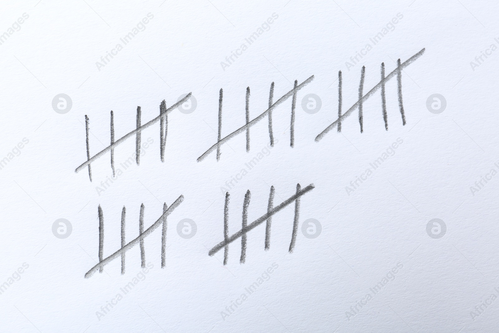 Photo of Counting days by drawing sticks with pencil on white background, closeup