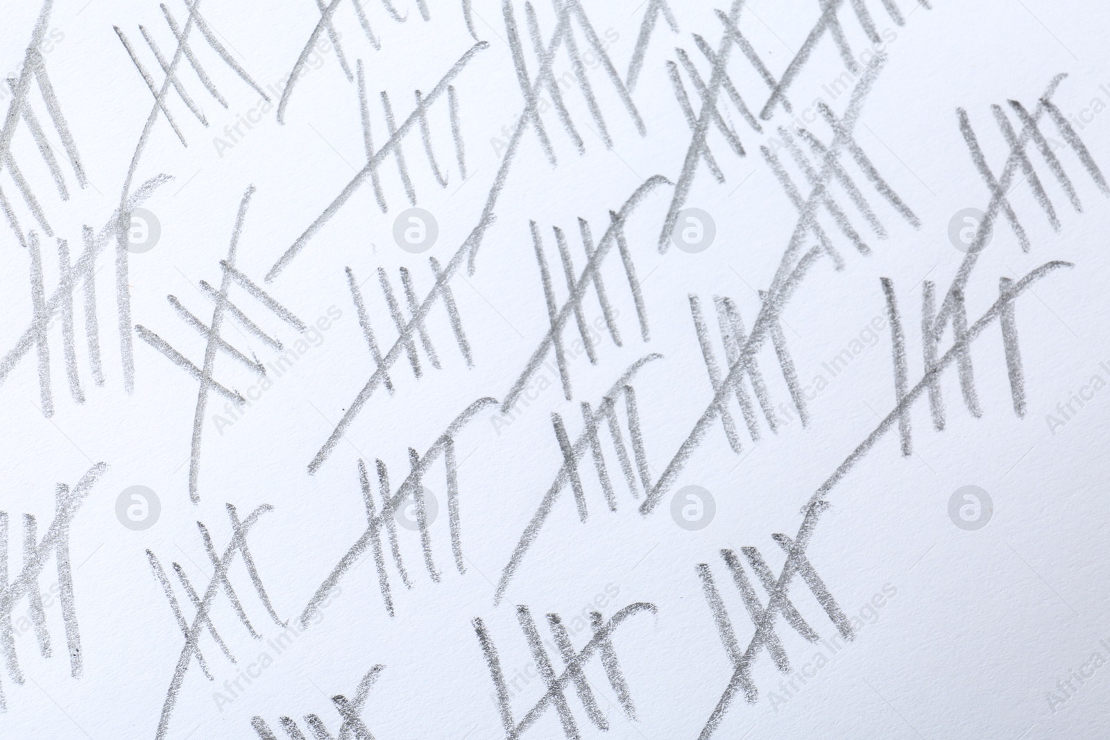 Photo of Counting days by drawing sticks with pencil on white background, closeup