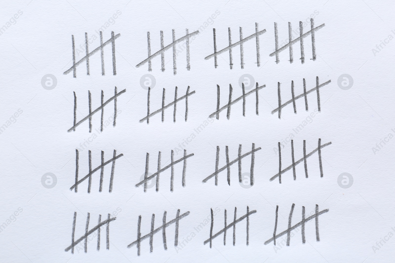 Photo of Counting days by drawing sticks with pencil on white background, closeup