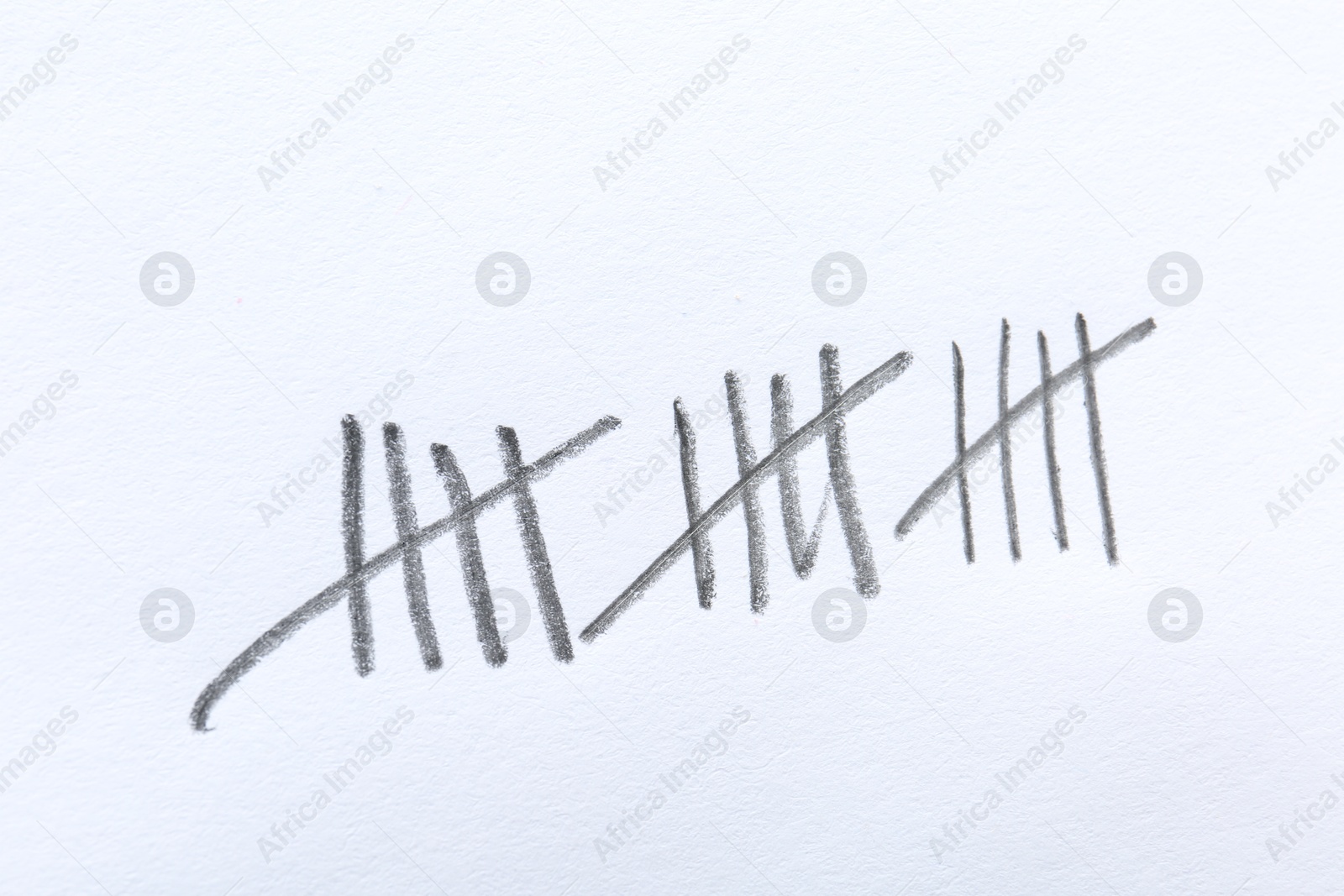 Photo of Counting days by drawing sticks with pencil on white background, closeup