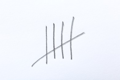 Photo of Counting days by drawing sticks with pencil on white background, closeup