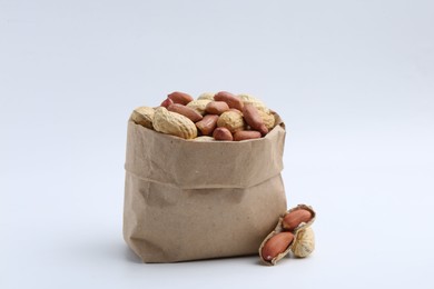 Fresh peanuts in paper bag isolated on white