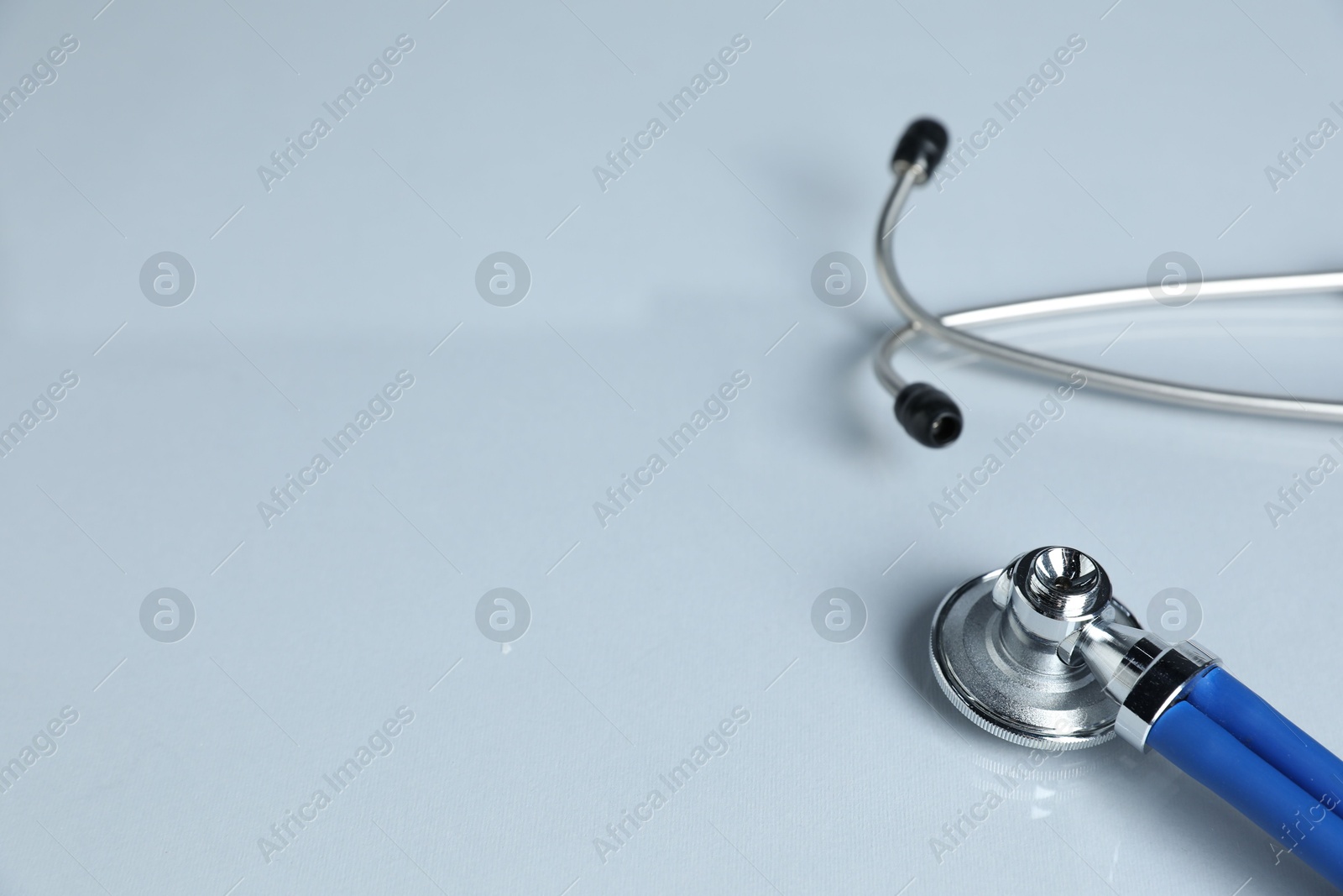 Stethoscope on light background, closeup. Space for text Photo of Stethoscope on light background, closeup. Space for text