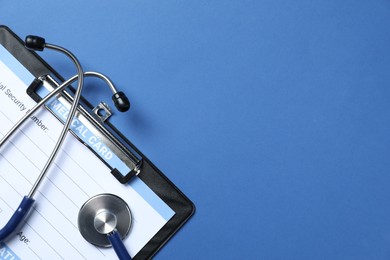 Photo of Stethoscope and medical card form on blue background, top view. Space for text
