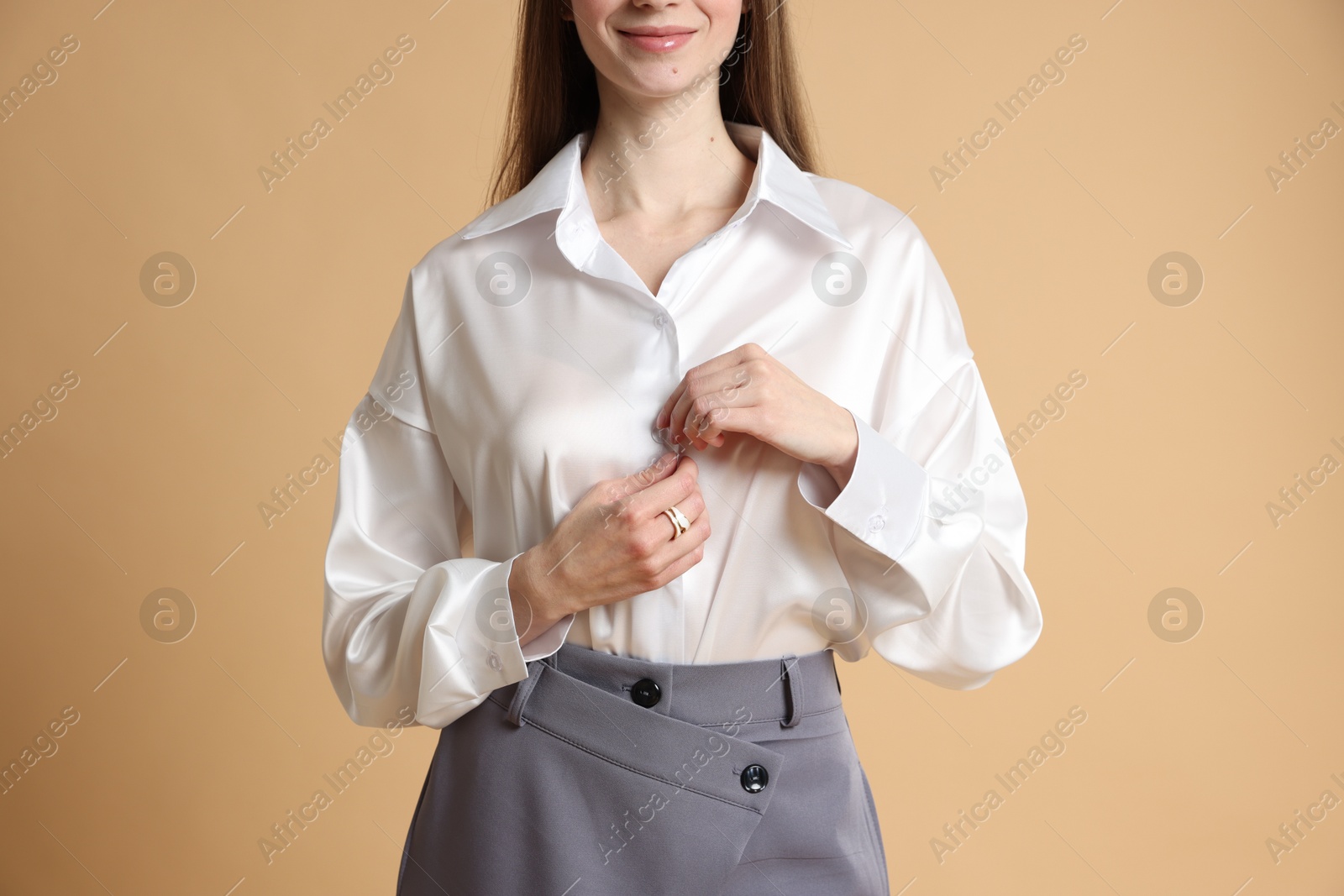 Photo of Beautiful woman in stylish outfit on beige background, closeup