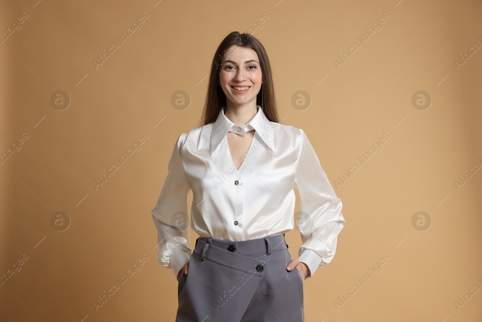 Photo of Beautiful woman in stylish outfit on beige background