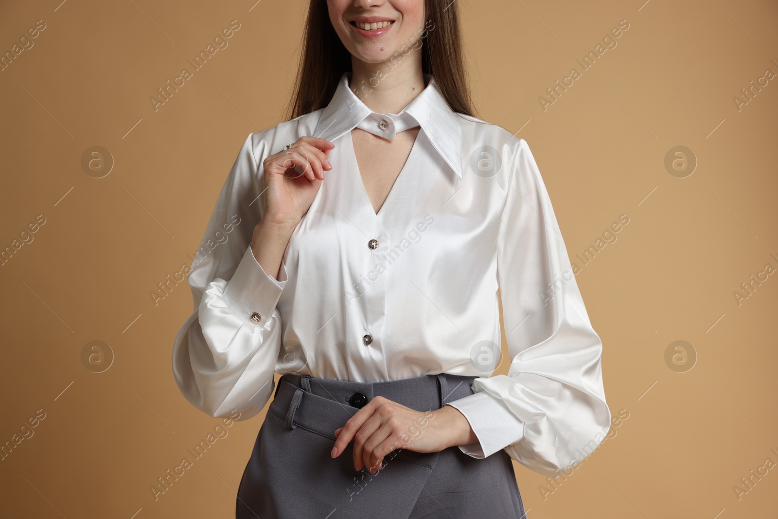 Photo of Beautiful woman in stylish outfit on beige background, closeup