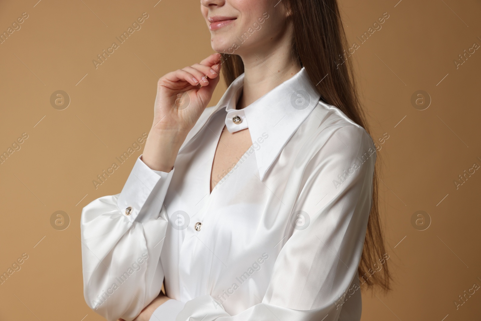 Photo of Beautiful woman in stylish outfit on beige background, closeup