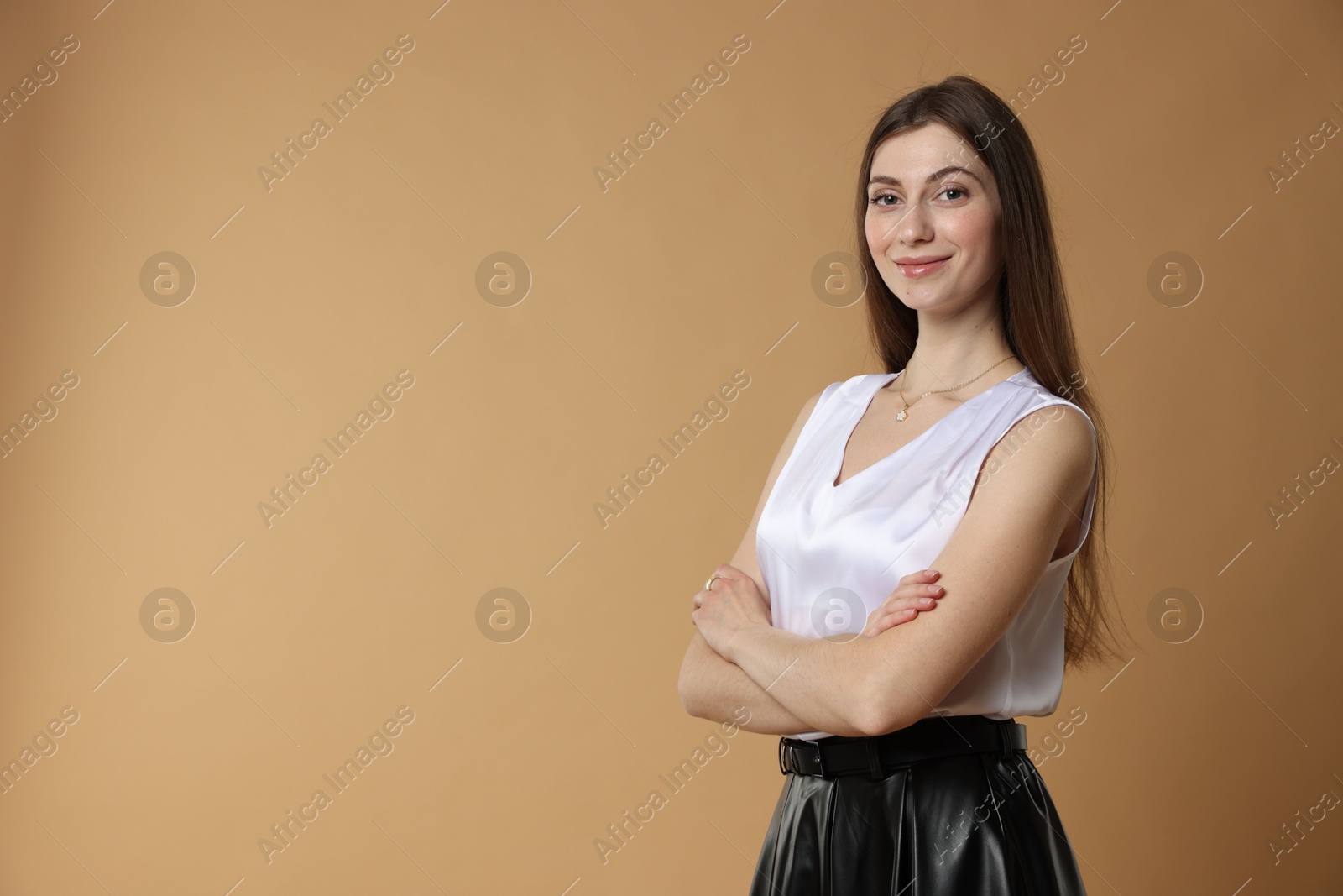 Photo of Beautiful woman in stylish outfit on beige background. Space for text