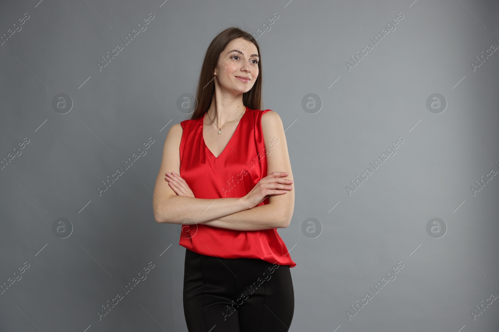 Photo of Beautiful woman in stylish outfit on grey background