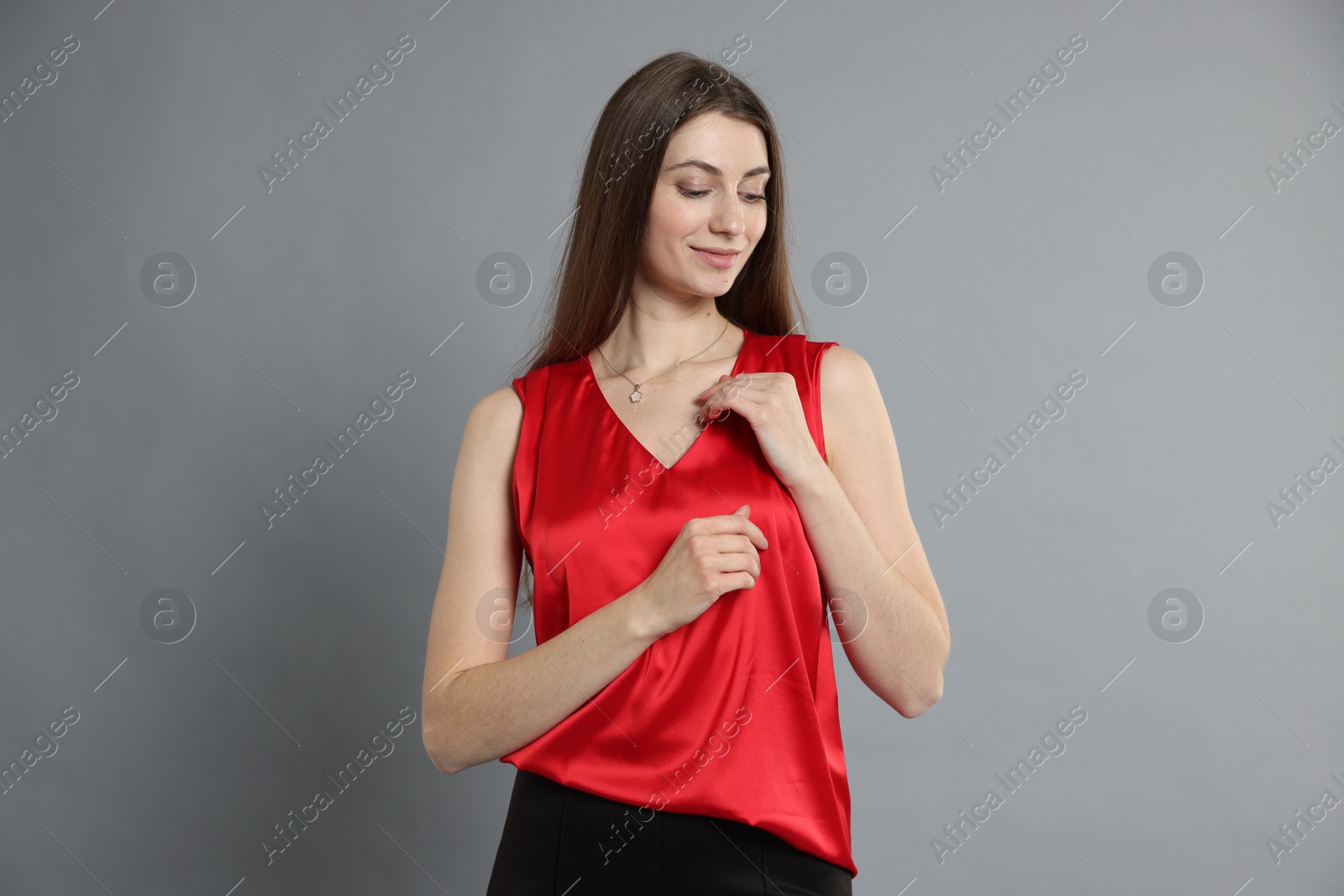 Photo of Beautiful woman in stylish outfit on grey background