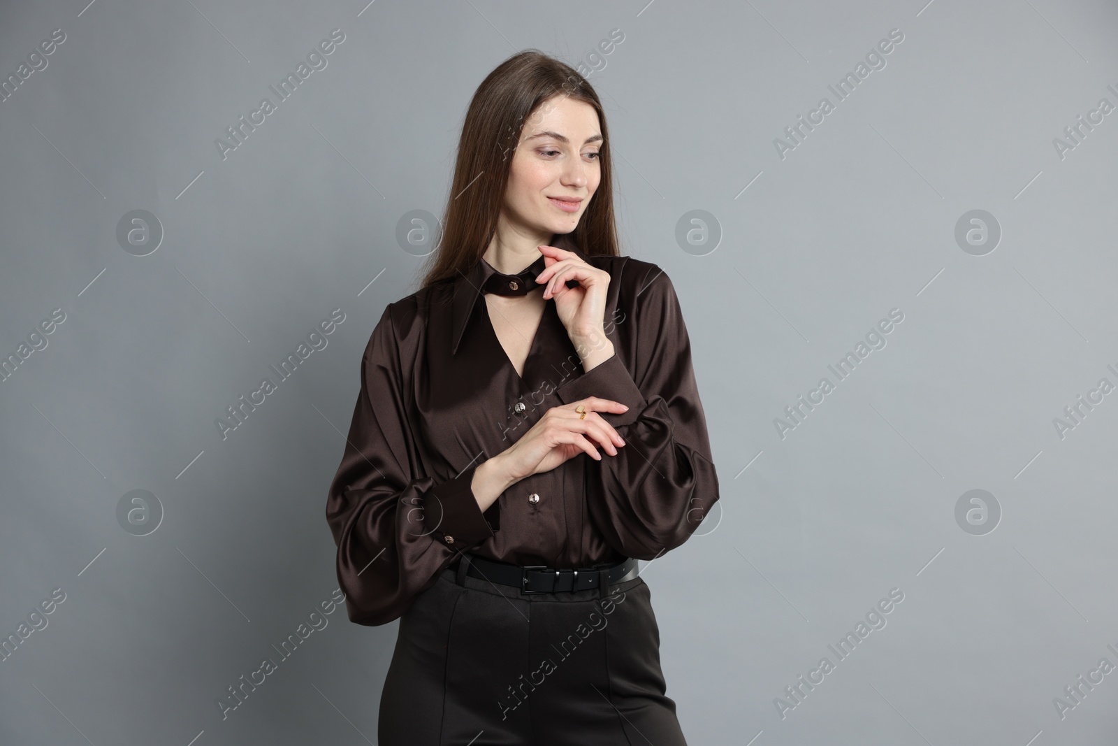 Photo of Beautiful woman in stylish outfit on grey background