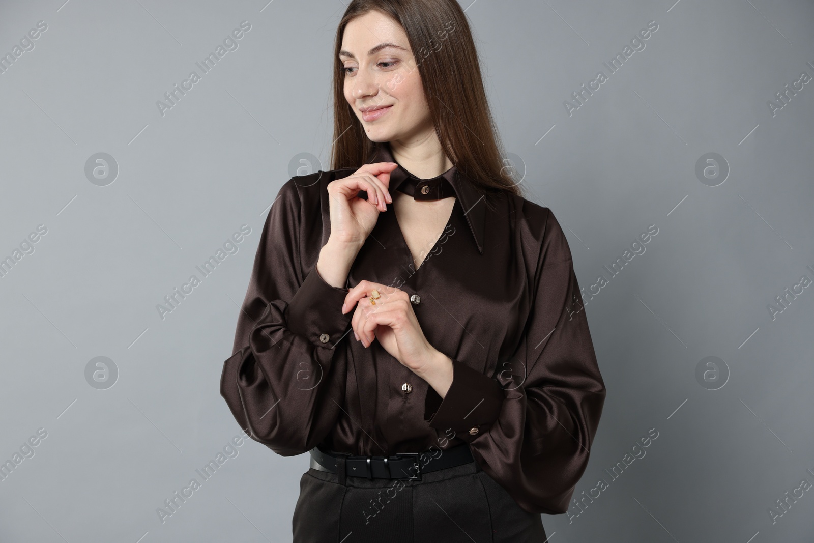 Photo of Beautiful woman in stylish outfit on grey background