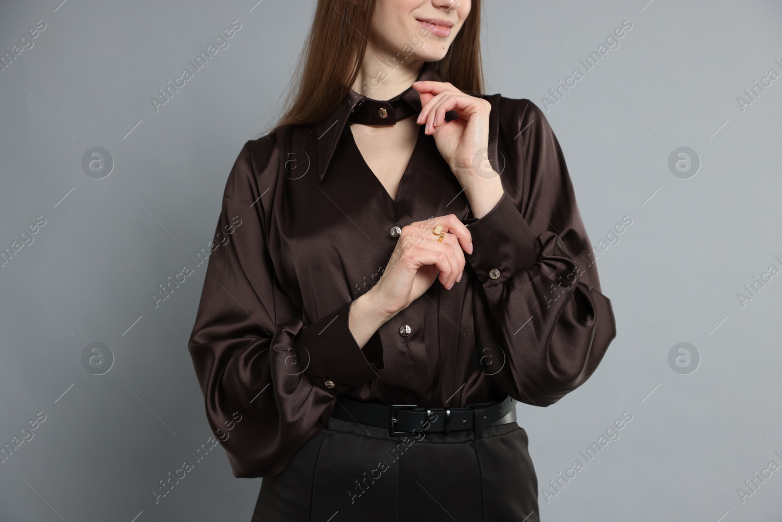 Photo of Beautiful woman in stylish outfit on grey background, closeup