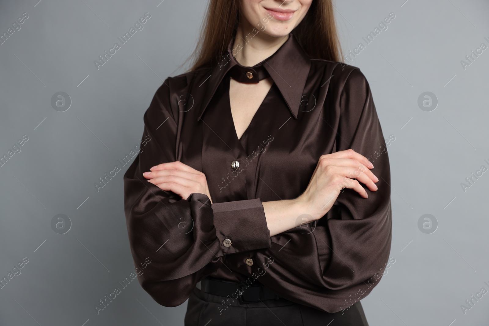 Photo of Beautiful woman in stylish outfit on grey background, closeup