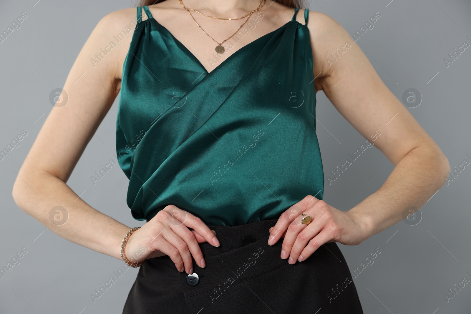 Photo of Beautiful woman in stylish outfit on grey background, closeup