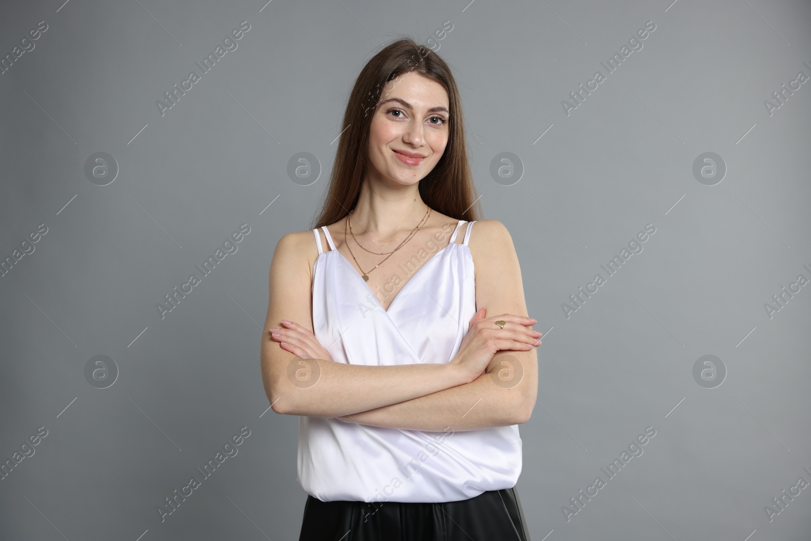 Photo of Beautiful woman in stylish outfit on grey background