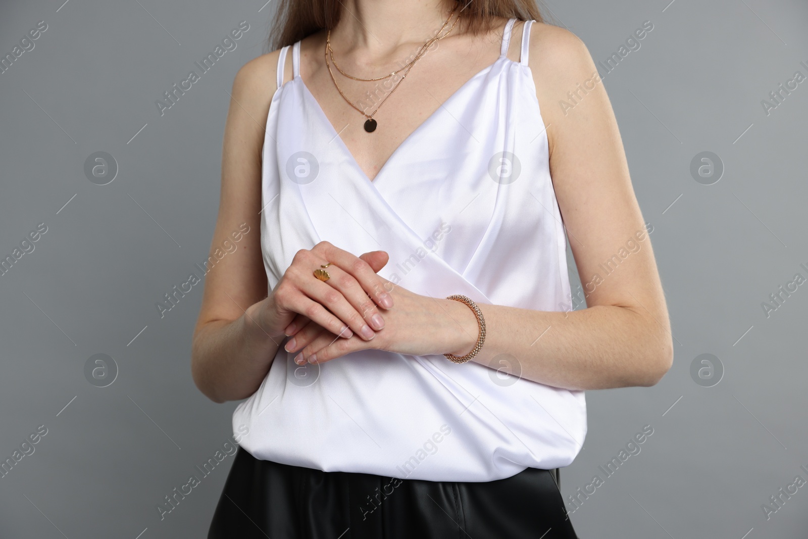 Photo of Beautiful woman in stylish outfit on grey background, closeup