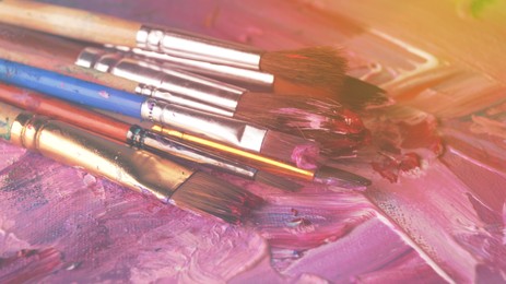 Image of Artist's palette with many brushes and mixed paints, closeup